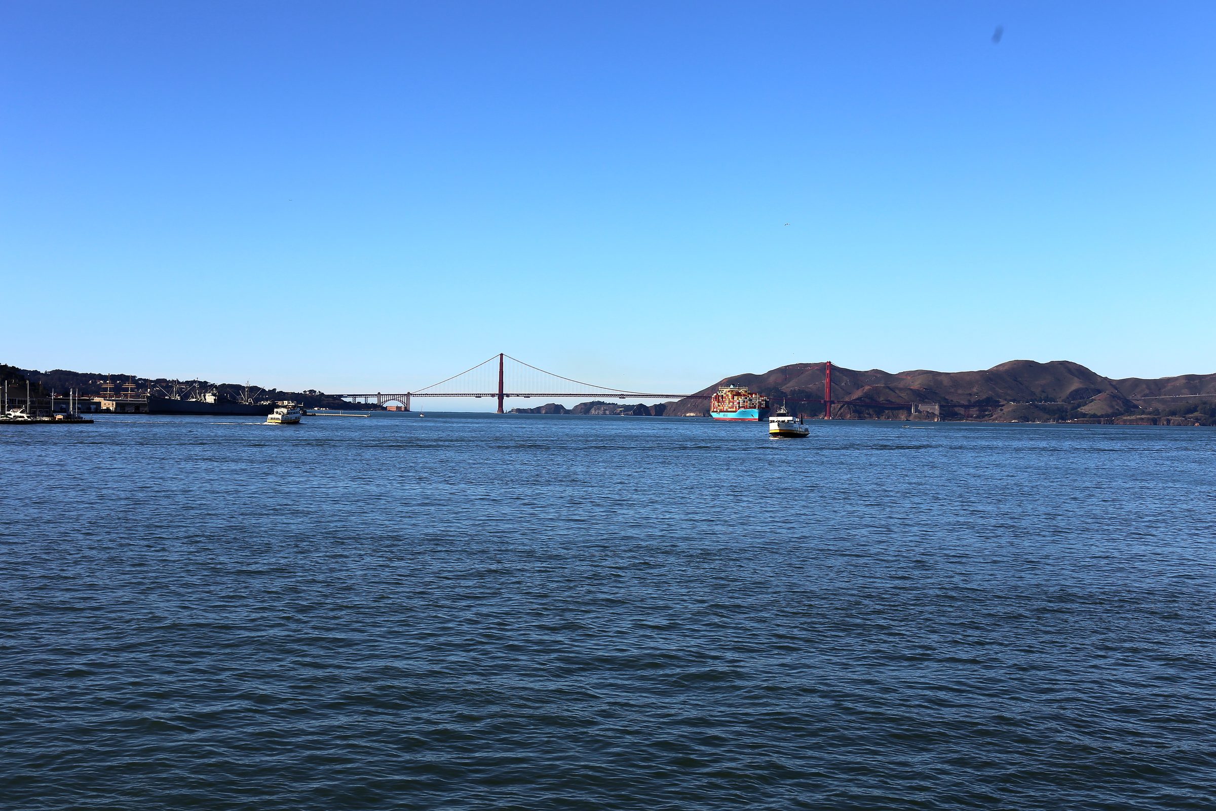 Blue bay looking toward the Golden Gate under bright clear sky.
