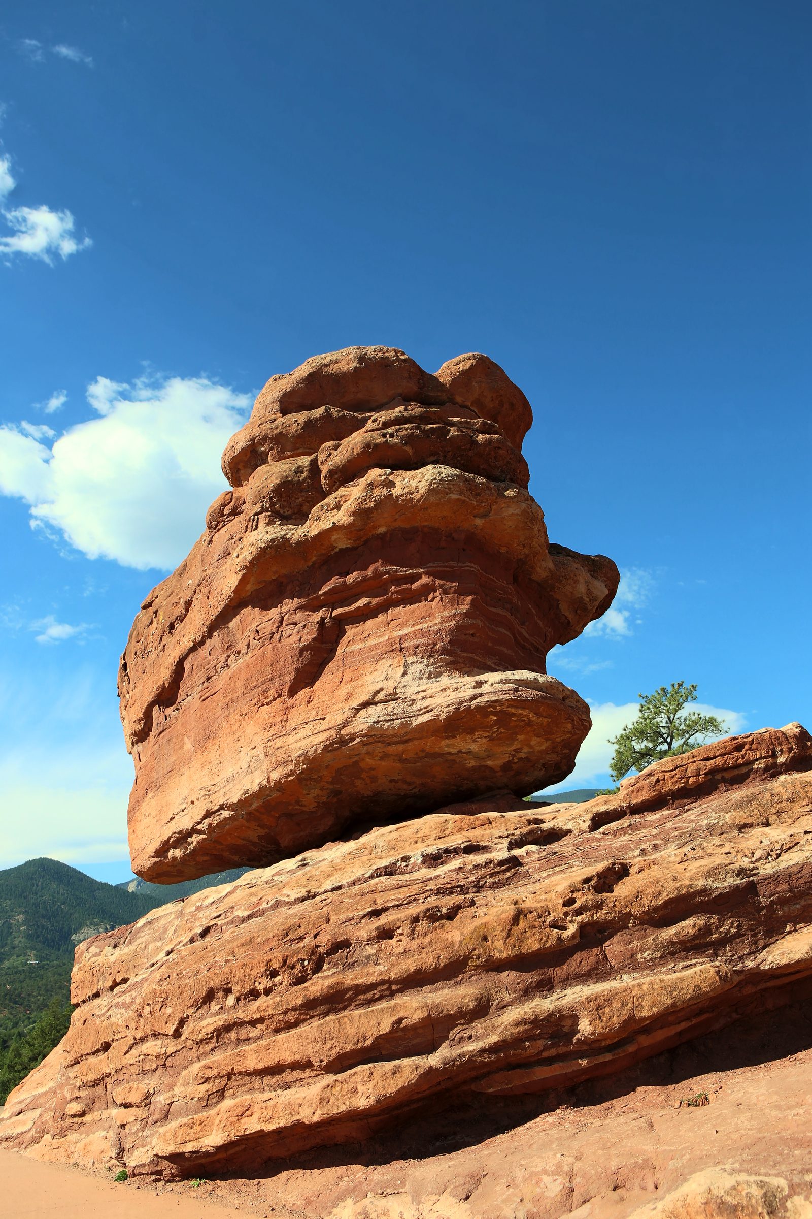 Balanced red rock formation against brilliant blue sky.