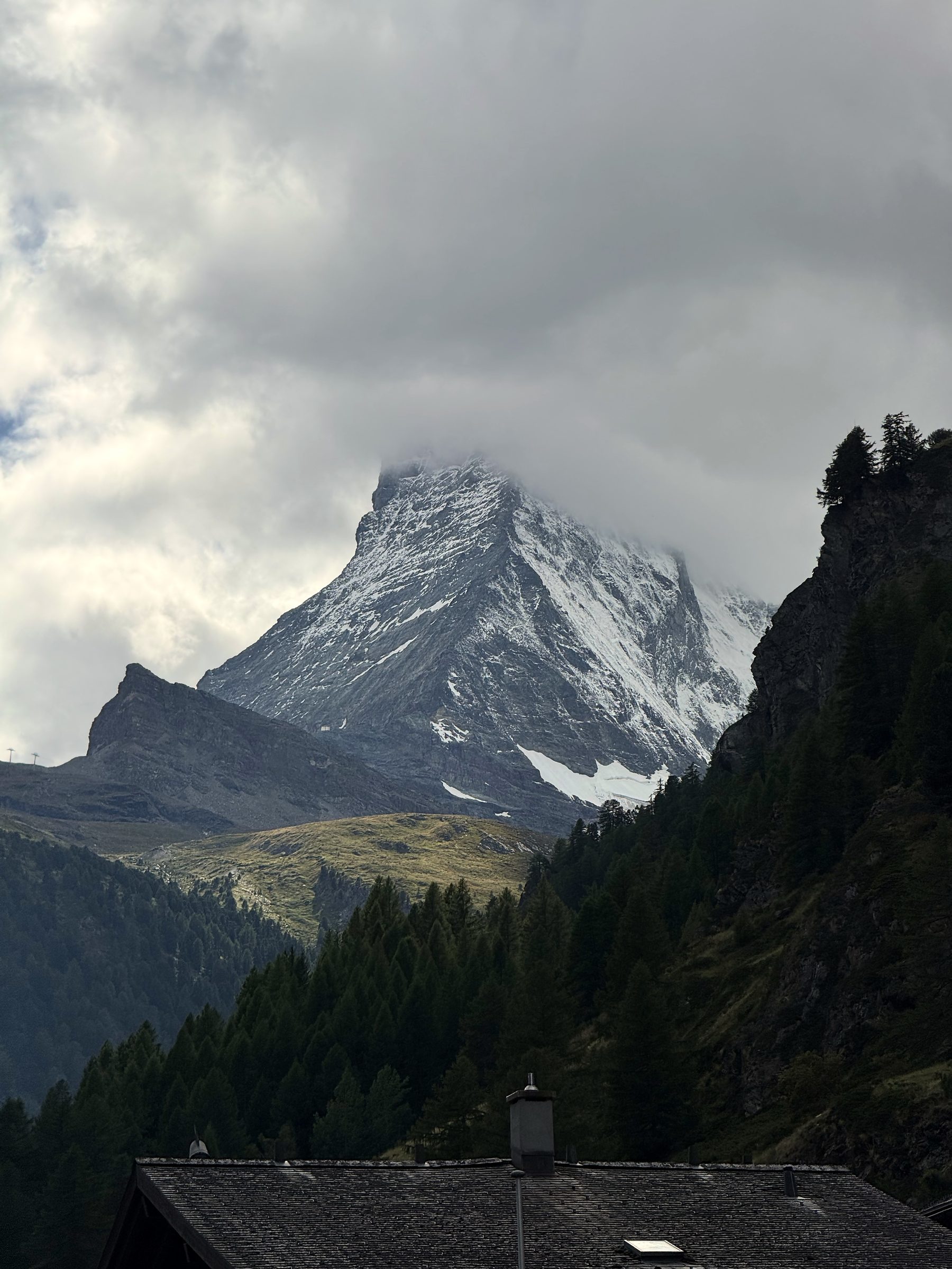Matterhorn half-swallowed by dark swirling cloud.