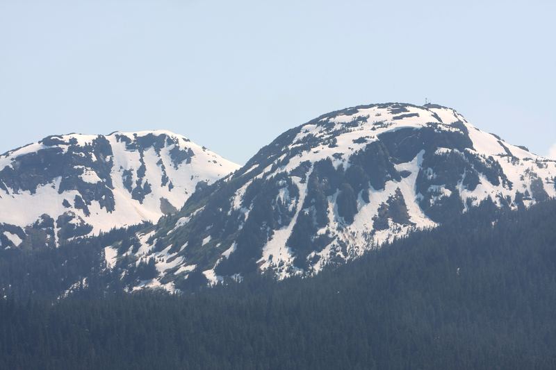 Twin snowy ridges against a clear blue sky.