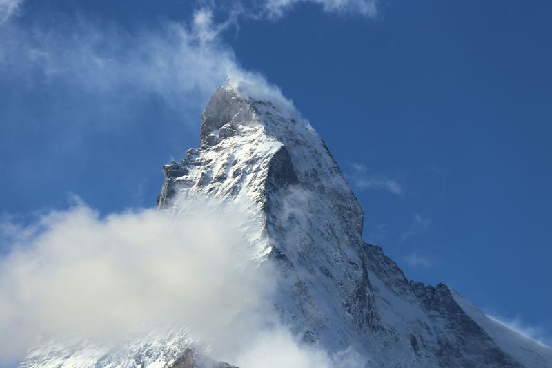 Matterhorn tip trailing a banner of windblown snow and cloud.