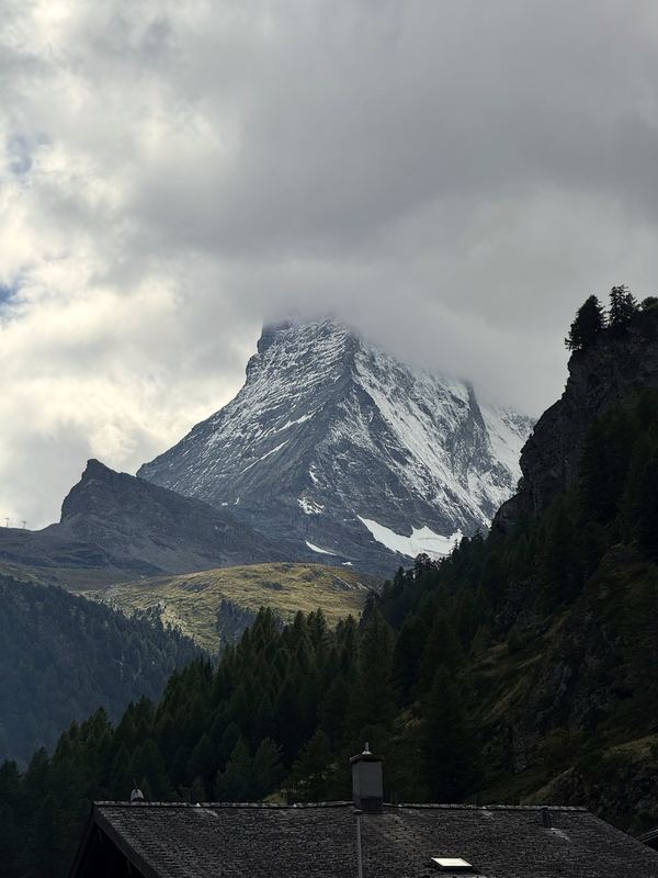 Matterhorn half-swallowed by dark swirling cloud.